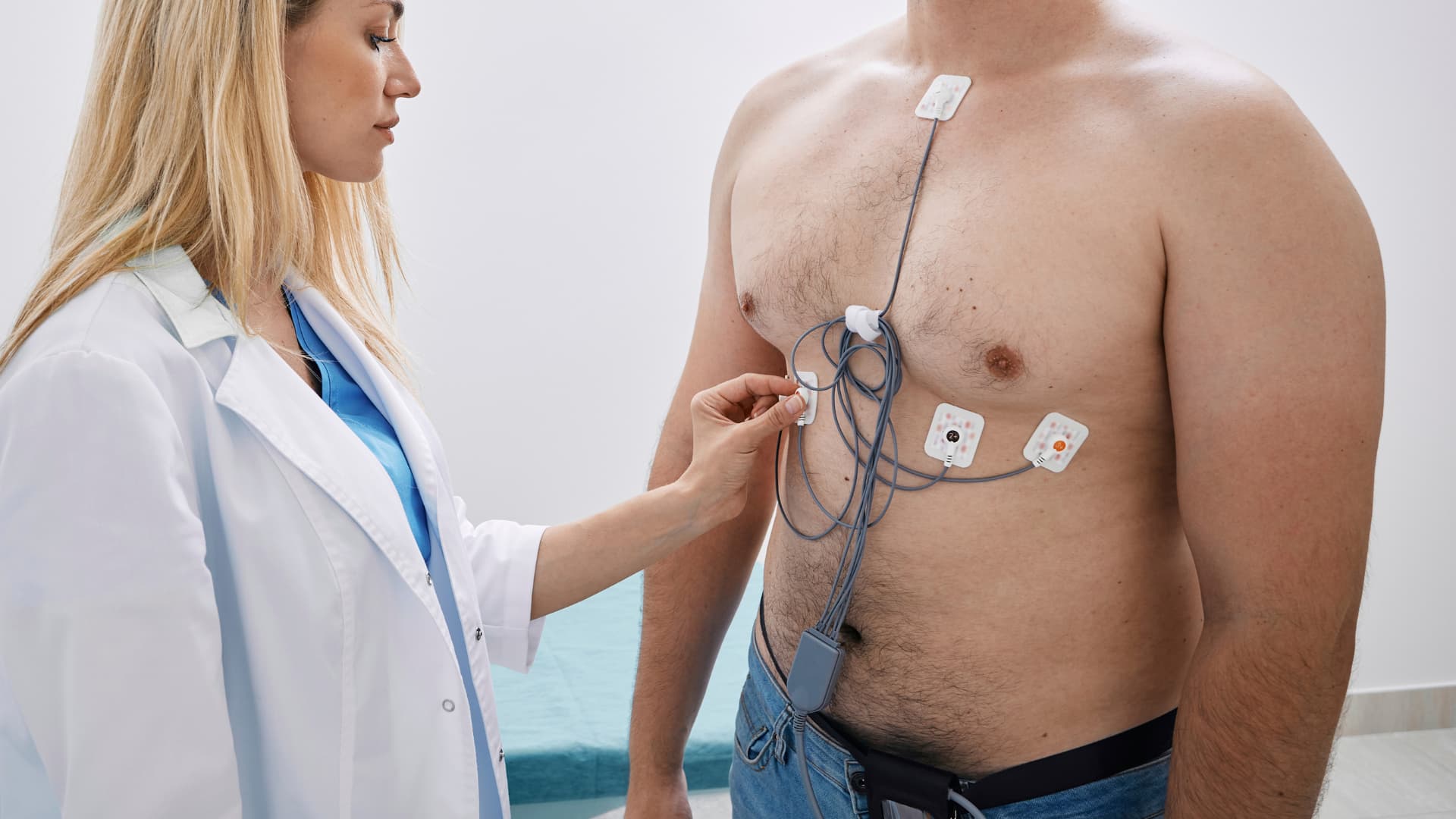médecin qui pose un ECG portable